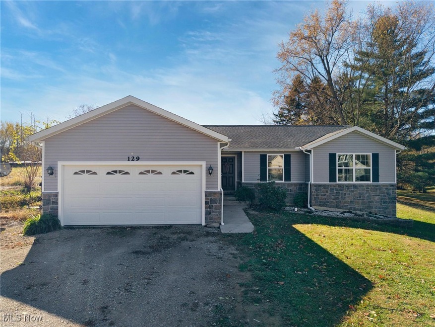 Gray ranch home with two-car garage at 129 Maple Ave, Woodsfield, Ohio