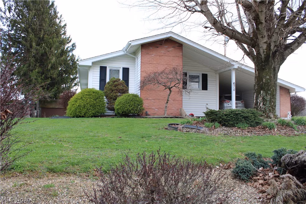 Ranch home with brick chimney and carport at 670 Lewisville Rd, Woodsfield, Ohio
